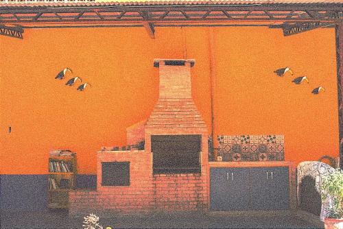 a painting of a fireplace on the side of a building at Hostal mburucuyá in Ciudad del Este