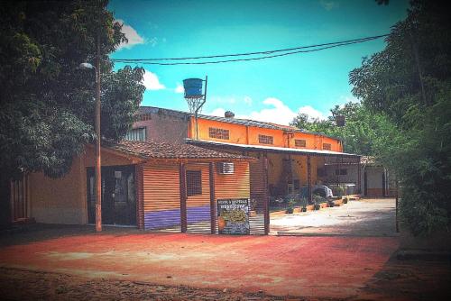 an orange building with a basketball court on top of it at Hostal mburucuyá in Ciudad del Este
