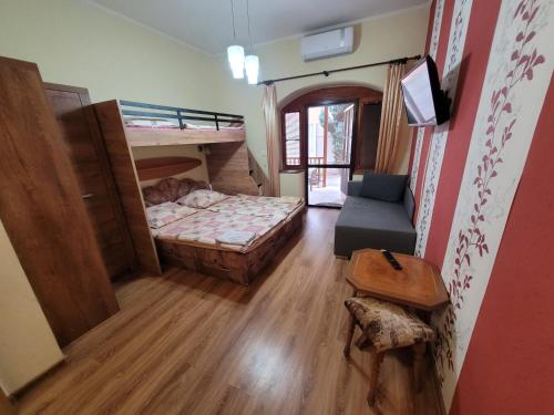 a small room with two bunk beds and a table at Penzión Korzo in Štúrovo