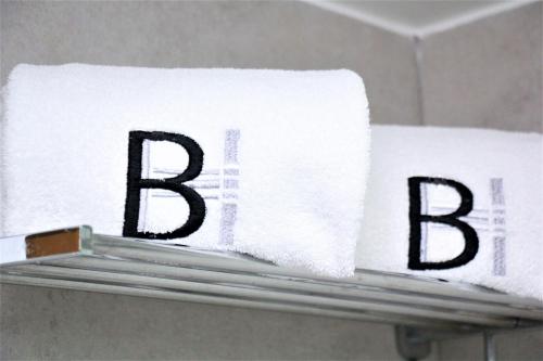 a pile of towels with the word bath on a shelf at Beverly Hotel Beirut in Beirut