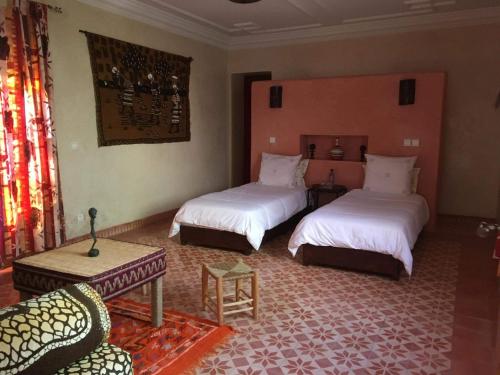 a bedroom with two beds and a couch in a room at CHATEAU D'ORIENT in Essaouira