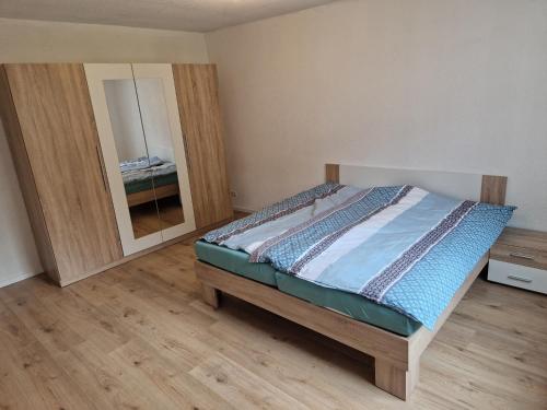 a bedroom with a bed and a large mirror at Ferienhaus Hofgasse in Günzburg