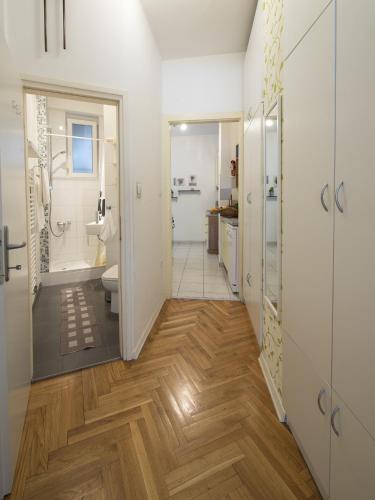 a hallway of a bathroom with a toilet and a sink at Main Square Apartment in Zagreb