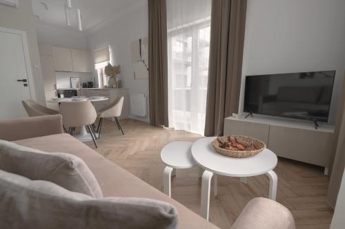 a living room with a couch and a table at APARTIO ROOMS Gliwice in Gliwice