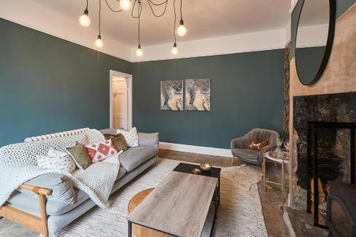 a living room with a couch and a fireplace at Host & Stay - Cobble Cottage in Lindley