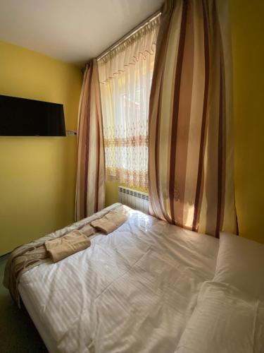 a bed with two towels on it in a bedroom at Zajazd Miechus in Miechów