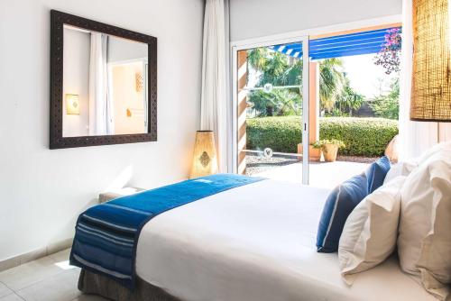 a bedroom with a large bed and a window at Paradis Plage Surf Yoga & Spa in Taghazout