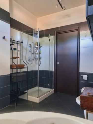 a shower with a glass door in a bathroom at -Le Carillon- Jacuzzi Suite Privé close to Bergamo in Sorisole