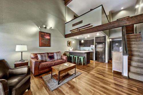 a living room with a couch and a table at Newly Remodeled Studio plus Loft- Lakeland Village condo in South Lake Tahoe