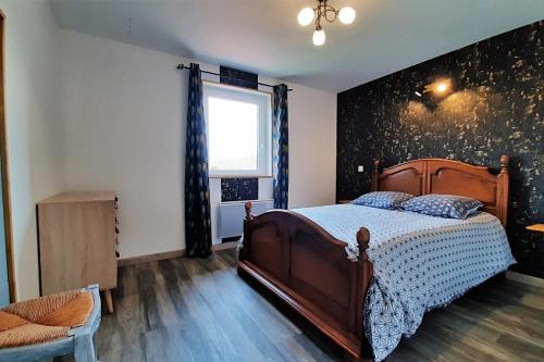 a bedroom with a wooden bed and a window at Villa Magnolia 8 personnes in Coubon