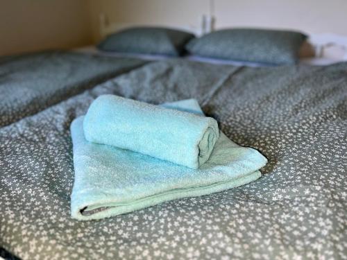 a pile of towels sitting on top of a bed at Relax in nature Apartment in Bovec