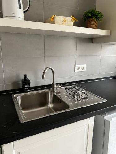 a kitchen counter with a stainless steel sink at Casa da Praça 2 in São João da Madeira