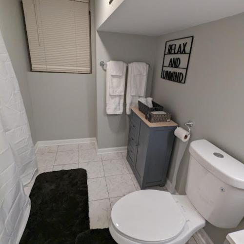 a white bathroom with a toilet and a sink at Fully Furnished Extended Stay Work or Insurance in Chicago in Chicago