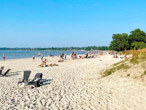 a beach with a lot of people on it at 4 person holiday home in BORGHOLM-By Traum in Borgholm