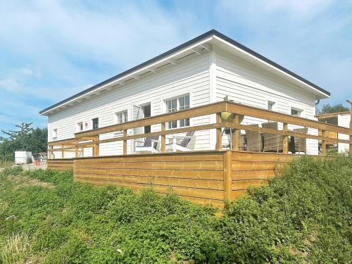 a white house with a large deck on a hill at 4 person holiday home in BORGHOLM-By Traum in Borgholm