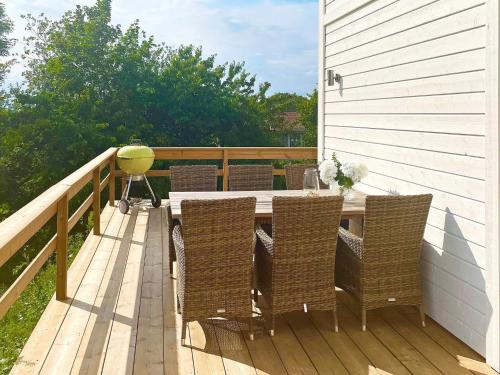 a patio with a table and chairs on a deck at 4 person holiday home in BORGHOLM-By Traum in Borgholm