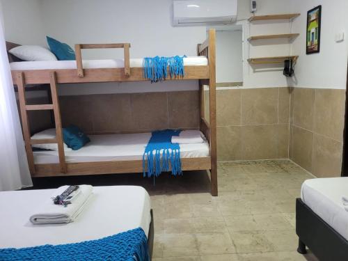 a room with two bunk beds and a shower at posada barrios mar in Cartagena de Indias