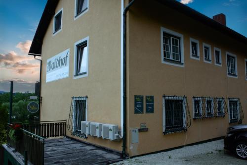 a building with a balcony on the side of it at Pension Waldhof am Stubenbergsee in Stubenberg