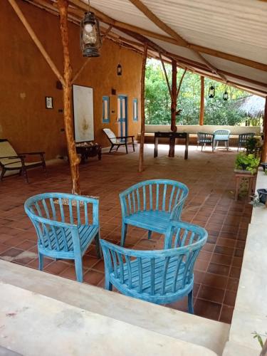 two blue chairs sitting on a tiled patio at Wild Wadi Wilpattu - Villas with private Plunge Pools in Wilpattu