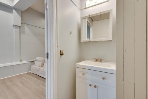 a white bathroom with a sink and a mirror at Cozy Scranton Studio Rental Pets Welcome! in Scranton