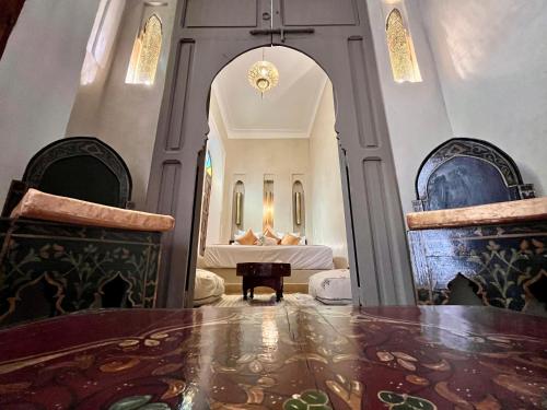a room with a table and two chairs and a bed at Riad Dar Zaouia in Marrakech