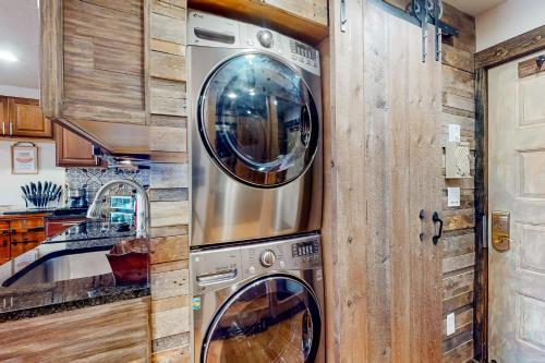 a kitchen with two washing machines in a wall at Charming Pad in Granby