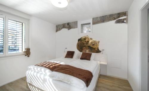 a bedroom with a bed in a white room at Hotel de la Concorde - Self Check-in in Vallorbe