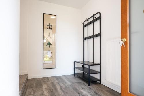 a hallway with a black shelf and a mirror at MYHOUSE APARTMENT in Cervignano del Friuli