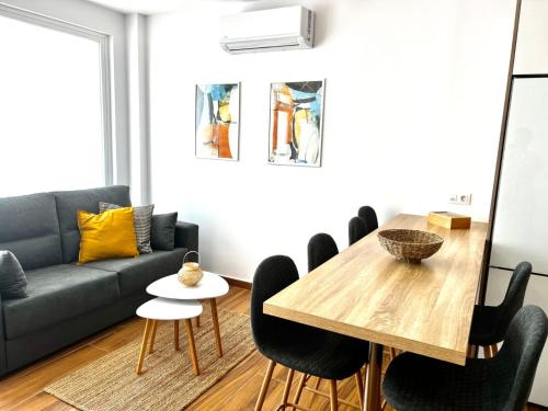 a living room with a table and a couch at Amber L5 in Armeñime