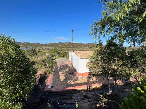 a house in the middle of a field with trees at Quinta with orange and lemon trees in Silves