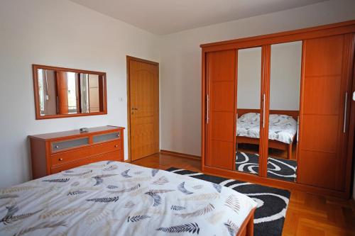 um quarto com uma cama, uma cómoda e um quarto com cama de casal. em Apartment GOLD em Podgorica
