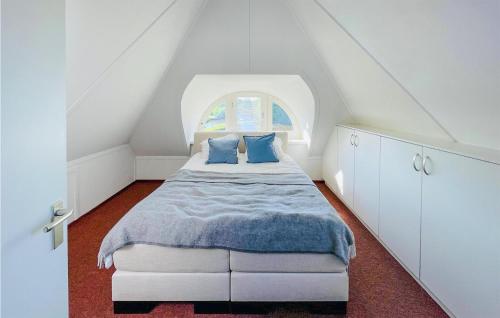 een slaapkamer met een bed en een zolderraam bij Nice Home In Sint Nicolaasga With House Sea View in Sint Nicolaasga