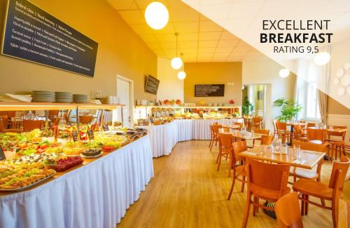 a restaurant with a buffet of food on display at Metropolitan Old Town Hotel - Czech Leading Hotels in Prague