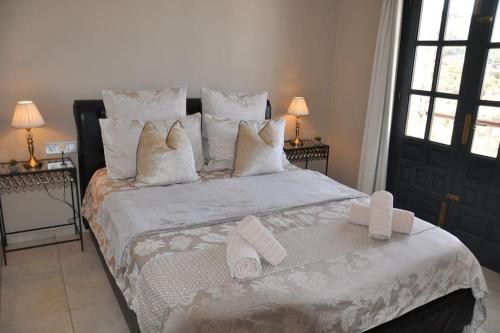 a bedroom with a large bed with towels on it at Villa with HEATED Pool and Amazing Mountain and Sea Views No Young Groups Allowed in Mojácar