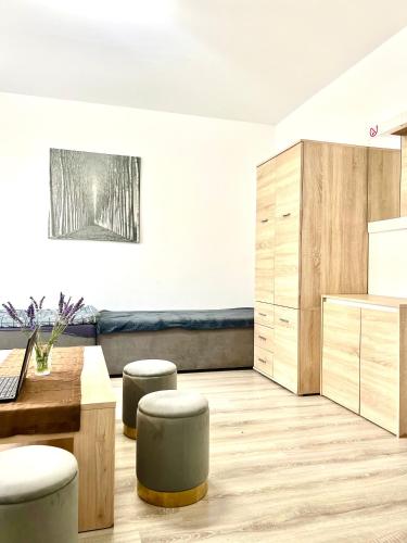 a kitchen with a table and stools in a room at Dom nad Jeziorami in Łubowo