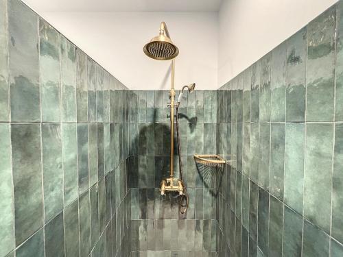 a bathroom with a shower with green tiled walls at Charmant appartement rénové - Central & Spacieux - Les Frères de la Loc' in Marseille