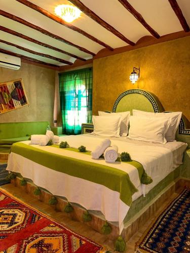 a bedroom with a large bed with towels on it at RIAD AMNAY in Taroudant