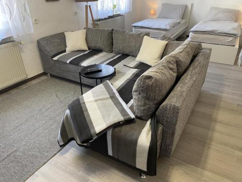 a living room with a couch and a bed at Schicke Ferienwohnung Philippsburg in Philippsburg