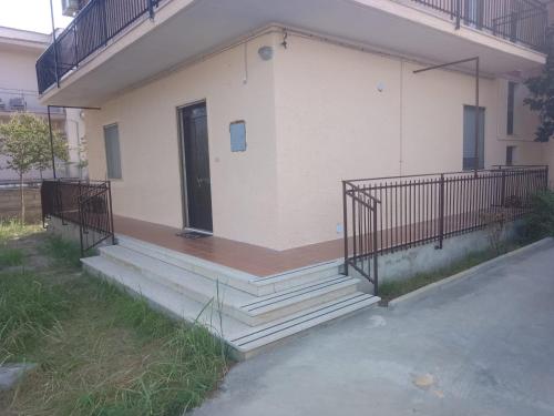 a building with a porch with a door and stairs at casa vacanze Policoro in Policoro