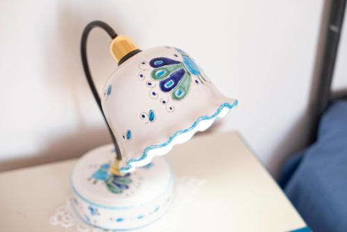 a tea pot with blue and white decorations on a table at Hotel La Casa sul Mare in Procida