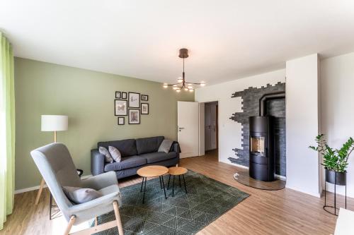 a living room with a couch and a fireplace at City-Luxus Apartment Rottweil in Rottweil