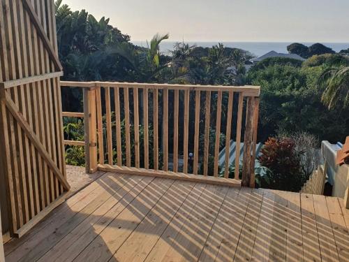 a wooden deck with a gate on top of it at Ocean Walk Manta in Zinkwazi Beach