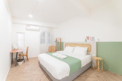 1 dormitorio con 1 cama grande y 1 mesa en Evergreen apartment by Beginning with, 3BR in heart of Nimman, en Chiang Mai