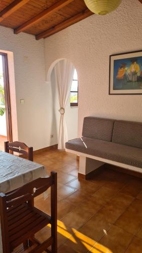 a living room with a couch and a window at RÉSIDENCE LES ARCADES in Almádena