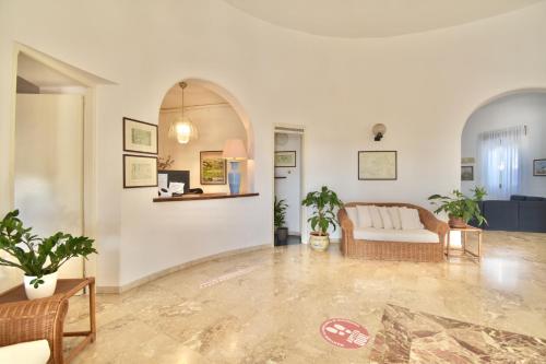 a living room with a couch and a table at Cossyra Hotel in Pantelleria
