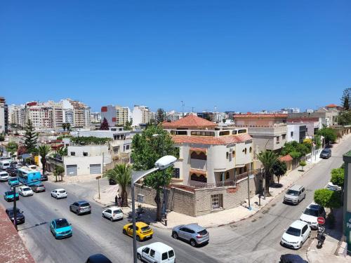 a city with cars parked on a street with buildings at Appartement Tanger 2 in Tangier