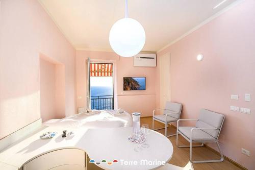 a room with a table and two chairs and a window at Sea-Cret, TerreMarine in Manarola
