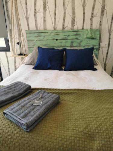a bed with a suitcase sitting on top of it at O Recuncho de Tibias in Pereiro de Aguiar