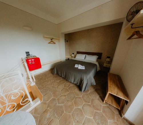 a small bedroom with a bed and a red lantern at La Casa delle Api in Offida