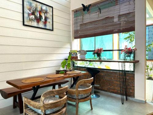 a dining room with a table and chairs at Adagaya Villa - Villa With Private Pool, Without Pool in Pantai Cenang